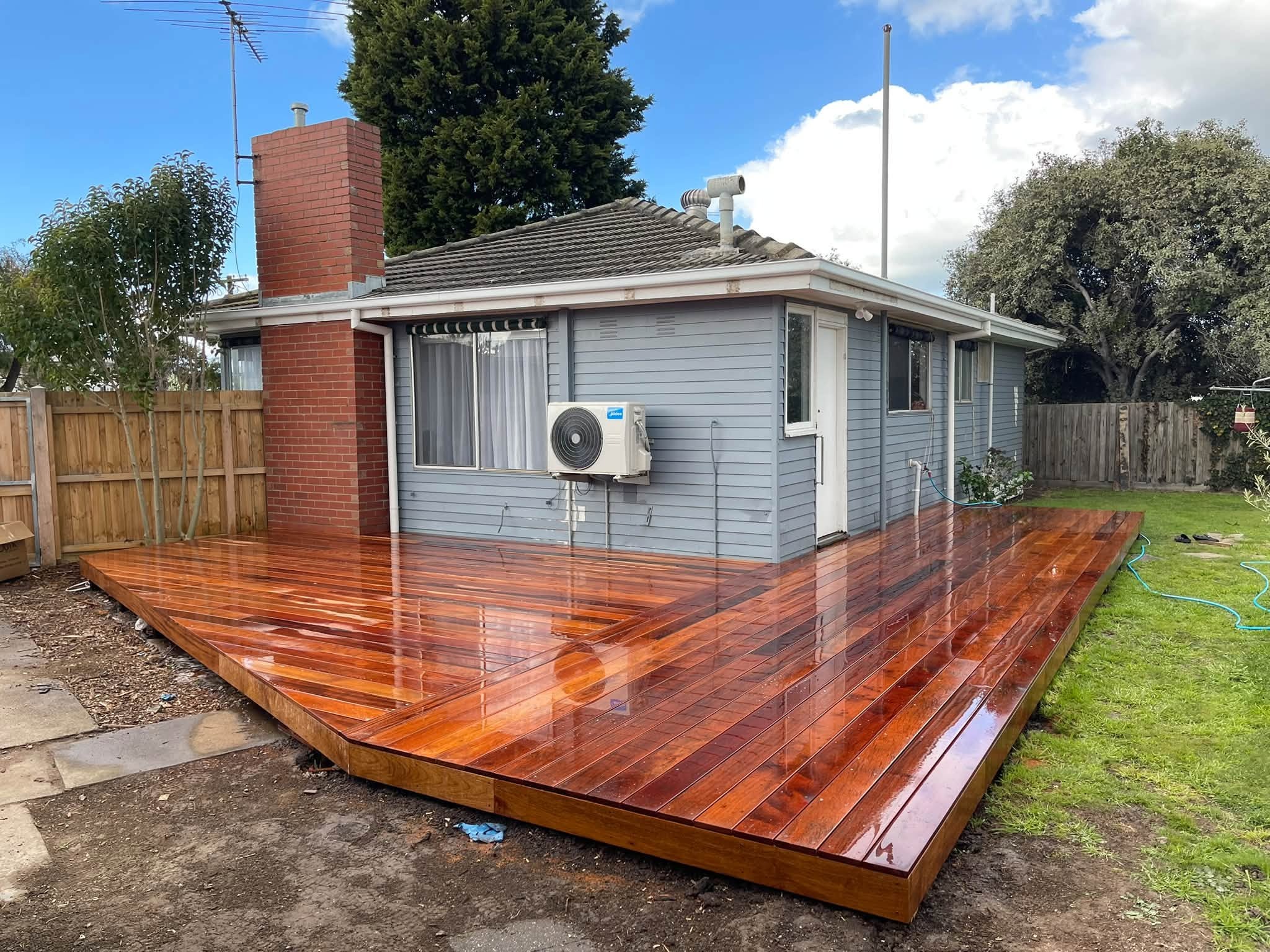 Completed wraparound timber deck with an angled corner and rich natural grain
